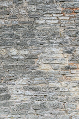 Old brick wall of different size sandstone bricks as a natural background