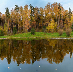 Moscow region. Golden autumn. Beautiful autumn landscape with reflection of trees in water