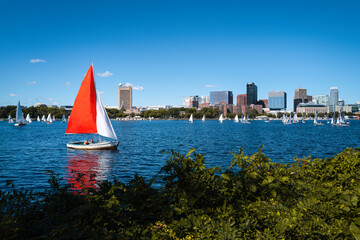 Fototapeta premium Boston landscape over Charles River with red and white yachts. Tranquil River scape from Charles River Esplanades.