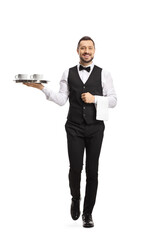 Full length portrait of a waiter serving coffee on a tray