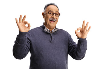 Fototapeta premium Mature man smiling and gesturing ok sign