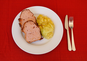 delicious traditional swabian leberkas with cold potato salad (a type of meat loaf popular in Germany and Austria)	