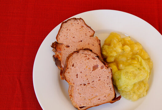 delicious traditional swabian leberkas with cold potato salad (a type of meat loaf popular in Germany and Austria)