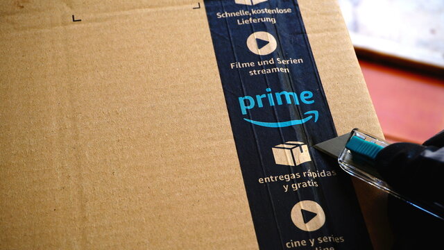Rome, Italy - March 04, 2019: Ribbon with Prime logo on Amazon cardboard with cutter. the largest e-commerce marketplace in the world, founded by Jeff Bezos on July 5, 1994