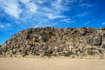 A hill with rock and boulders on a hill at Horsemen’s Center Park in Apple Valley, California