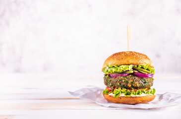 Vegan burger on a white table and with a white background. Vegetable meat. Ready to eat. 