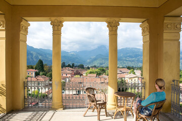 Lady enjoys the view from a Tuscany Villa. 