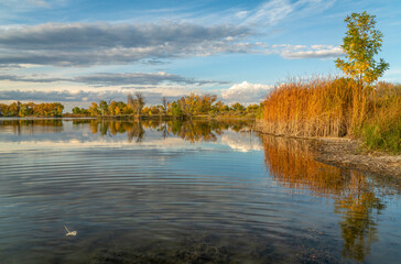 calm lake at sunset in one of Fort Collins natural areas in northern Colorado, fall scenery