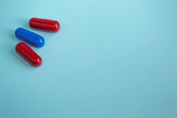 Medical concept on blue background medical capsules blue and red