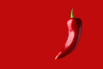 Chili peppers on a red background close-up.