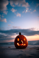 pumpkin jackolantern beach sunset for halloween 