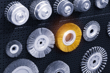 Set of various disk brushes. Round brushes with metal pile or bristles for processing materials. industrial tools for metal working concept background