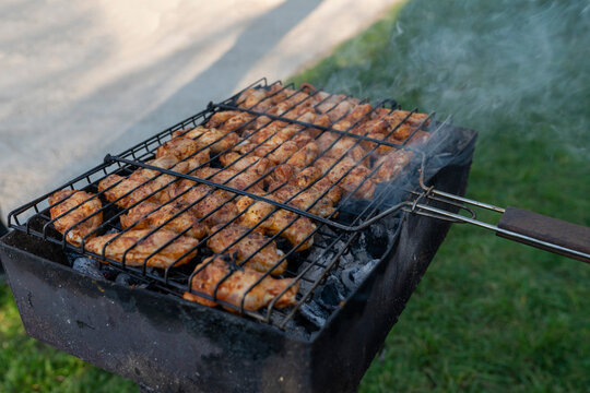 Tasty chicken legs and wings on the grill.