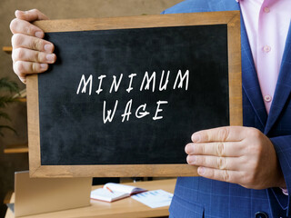  MINIMUM WAGE sign on the chalkboard.