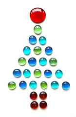 Christmas tree shape made of glass drops on white background.