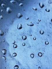 water droplets on a metal plate with holes, close-up. Macro photo