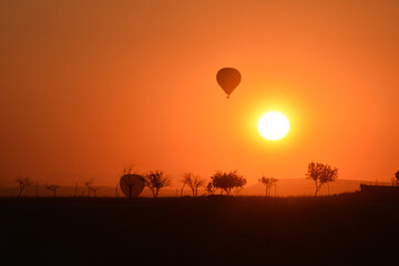 hot air balloon in nature at sunrise