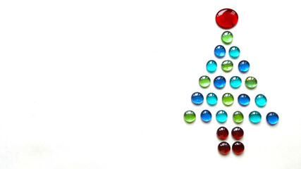 Christmas tree shape made of glass drops on white background.
