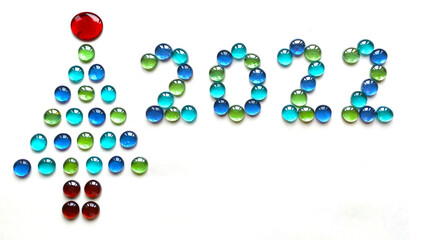 Christmas tree shape and numbers 2022 made of glass drops on white background.