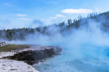 Obraz premium Excelsior Geyser, which located in the Midway Geyser Basin in Yellowstone National Park, drains 4,000-4,500 gallons of water per minute into the Firehole River.