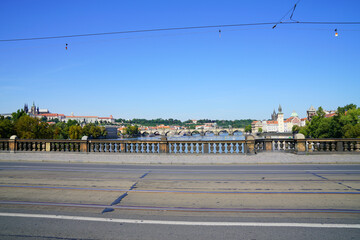 Fototapeta premium Palacky Bridge with tramlines and cables overlooking Vltava River and city skyline