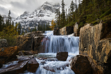 Giant Steps Waterfalls against Mt. Lefroy covered with fresh snow in autumn. Banff National Park. Canadian Rockies. Alberta. Canada