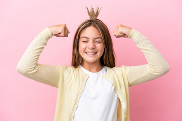 Little princess with crown isolated on pink background doing strong gesture