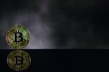 Bitcoin Cryptocurrency with blurred computer screen textured background, reflection of coin and copy space. Gold bitcoin, the future coin, digital currency. Conceptual of blockchain technology market
