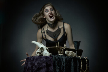 Dark sorceress casting a magic spell with an animal skull