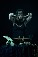 Dark sorceress casting a magic spell with an animal skull