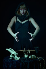 Obraz na płótnie Canvas Dark sorceress casting a magic spell with an animal skull