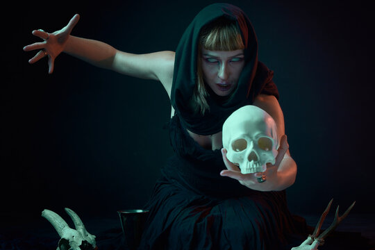 Dark sorceress casting a magic spell with an animal skull