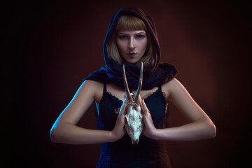 Dark sorceress casting a magic spell with an animal skull