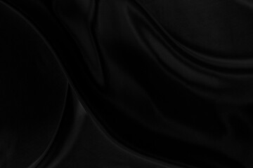 Black gray satin dark fabric texture luxurious shiny that is abstract silk cloth background with patterns soft waves blur beautiful.