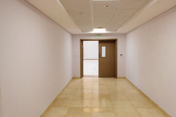 hallway with celling and double door half open