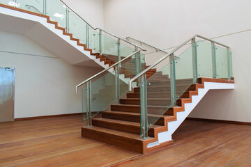 wooden stairs with glass and metal handles
