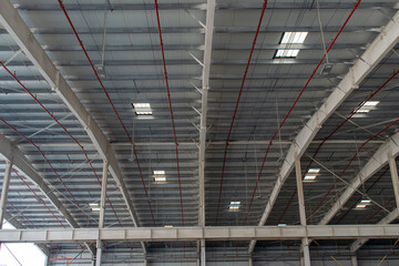 Metal warehouse roof interior with fire equipment 