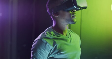 African american male computer technician using vr headset working in business server room - Powered by Adobe