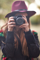 Woman photographer holding a dslr camera