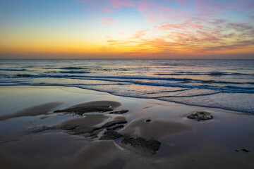 Fototapeta na wymiar Aerial sunrise seascape with high cloud and gentle surf