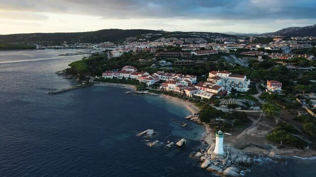 Sunrise at the coastal village of Palau in northern sardinia. perfect for vacation, clear blue water. romatic small lighttower in the corner. Drone aerial view sideways, Sardinia Italy
