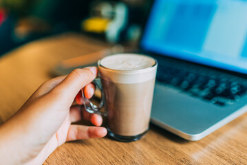 home office desk with a cup of mochacino, a computer and decorative objects