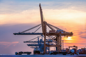 Obraz premium Cargo ship parking at seaport waiting for container dock crane shipment harbour loading container boxes import and export commercial trade business logistic and transportation of international.