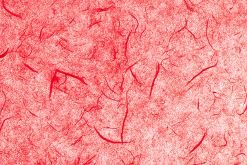 light red mulberry paper . Abstract background with small details of paper with natural fibers. Top view for copy spaces, designs, and advertisements