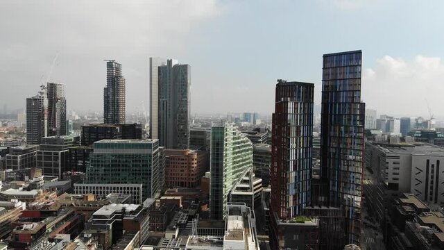 Aerial view, flying over tall building near Liverpool Street Station on a hazy sunny day