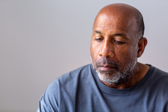 Portrait of a mature man looking sad and away from the camera.