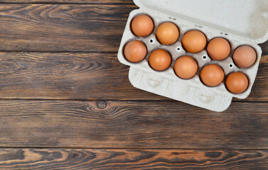 fresh homemade farm eggs in eco packaging on a concrete table, the concept of delivery and packaging of organic products.