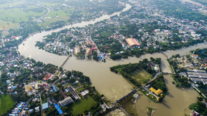 Flood waters overtake a house and rice field at Central of Thailand in 2021. Many buildings are...