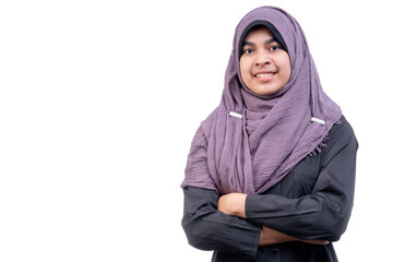 Obraz na płótnie Canvas A beautiful Asian Muslim teenage girl is smiling, on an isolated white background, with copy space.