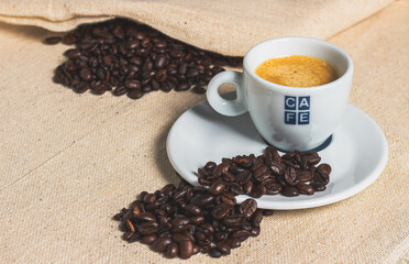 Espresso coffee in textured cloth with details of coffee beans.